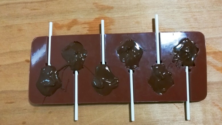 巧克力鱼棒棒糖,将融化的巧克力倒入模具，放入冰箱冷藏三小时