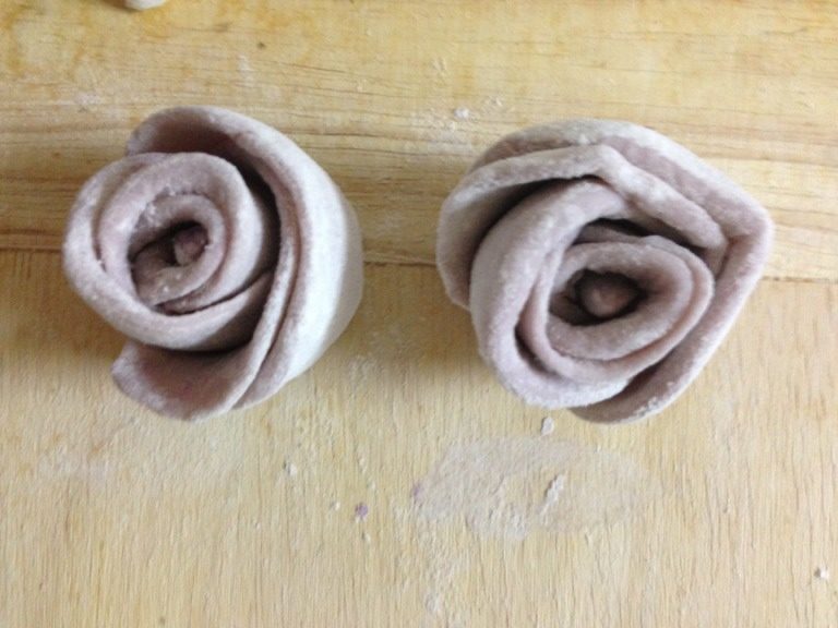 紫薯花卷,将面皮卷成筒状按照筷子印左右分旋掐断，两朵花完成了；
