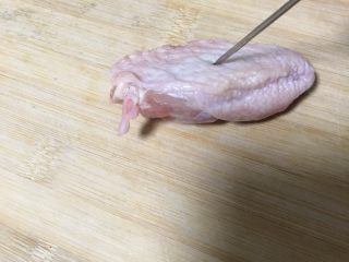 奥尔良烤鸡翅,在鸡翅两面轧孔，轧孔可以让调料入味，也能防止表皮烤爆裂，