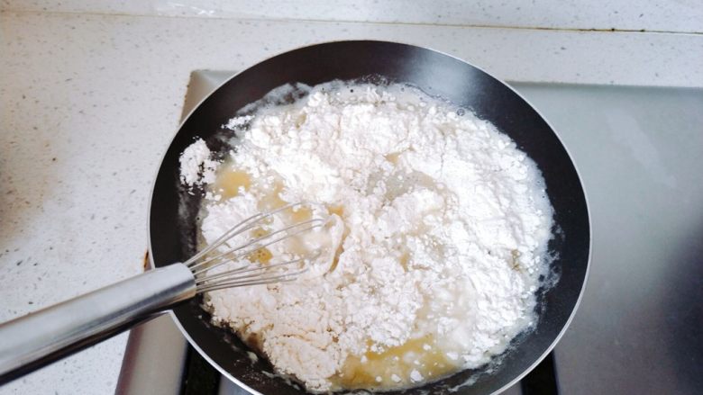 奶油泡芙球,快速搅拌（最好用打蛋器），让热水把低粉烫熟，搅拌到没有干粉，就可以关火了。如果这步没有搅拌到完全融合，后面的泡芙球烤的时候可能不膨胀，而且口感不好。