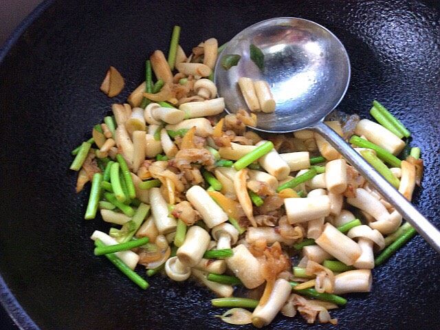 白玉菇蒜苔炒蚬子肉,放少许盐，翻炒均匀即可出锅