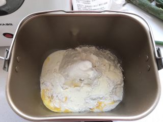 桃李毛毛虫奶油面包,先将除了黄油和酵母粉之外的做面包主体的材料都混合到一起放在面包机内。