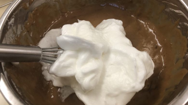 微润红糖栗子🌰戚风蛋糕,勺三分之一蛋白霜加入蛋黄糊中搅拌均匀。