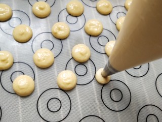 童年蛋黄小饼干,直径1～2厘米一个，按顺序挤好，不要离的太近，面糊会扩散免得粘在一起，烤盘最好垫油纸或者硅胶垫在挤面糊