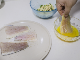 脆皮花生巴沙鱼块配酸辣酱,将鱼块裹上蛋液
