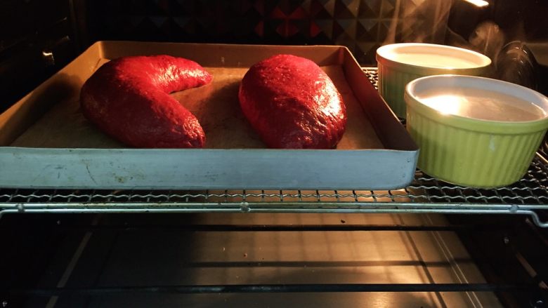 红丝绒麻薯软欧包,将整形好的面团放入烤箱，开发酵模式进行二次发酵，可以在烤箱放两碗温<a style='color:red;display:inline-block;' href='/shicai/ 156925'>水</a>模拟湿润环境，二次发酵40～60分钟