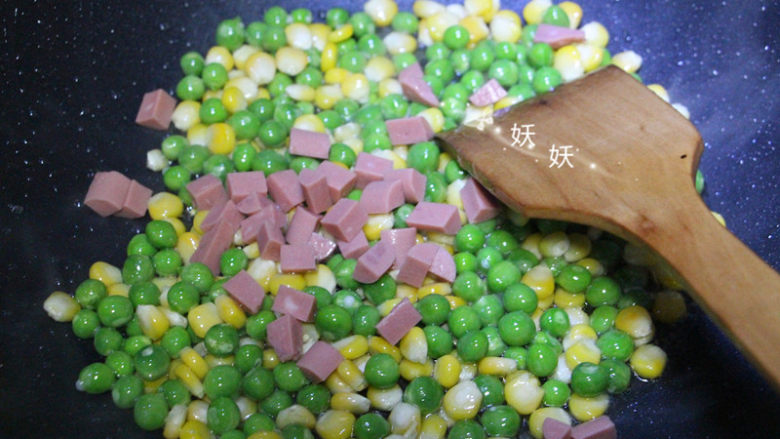 炒三丁,待豌豆和玉米粒变色，加入火腿肠丁翻炒，火腿肠是熟的，最后放提提味就可以。