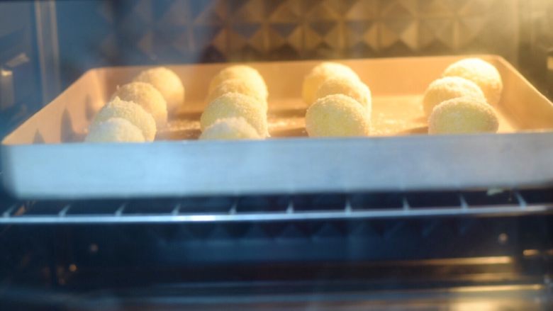 黄金椰蓉球,放入预热好的烤箱，上下火180度，中层15分钟