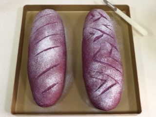 紫薯麻薯夹心软欧,发至两倍大时取出面包，在表面筛一层薄薄的高筋面粉，用锋利的刀片在面包表面刮出纹理。