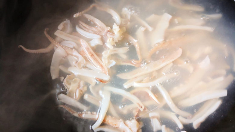 鱿鱼炒香芹,锅里加入适量清水，烧至快开锅，放入鱿鱼，焯水30秒，