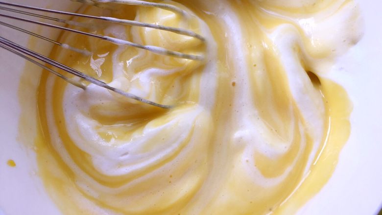 奶油蛋糕卷,取三分之一打发好的蛋白，加入到蛋黄糊中用蛋抽翻拌均匀，烤箱预热170度