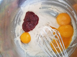玫瑰奶茶草莓戚风 ,分离蛋清和蛋黄，蛋清需放在无水无油的容器中，放入冰箱冷冻层备用。加入蛋黄和草莓酱