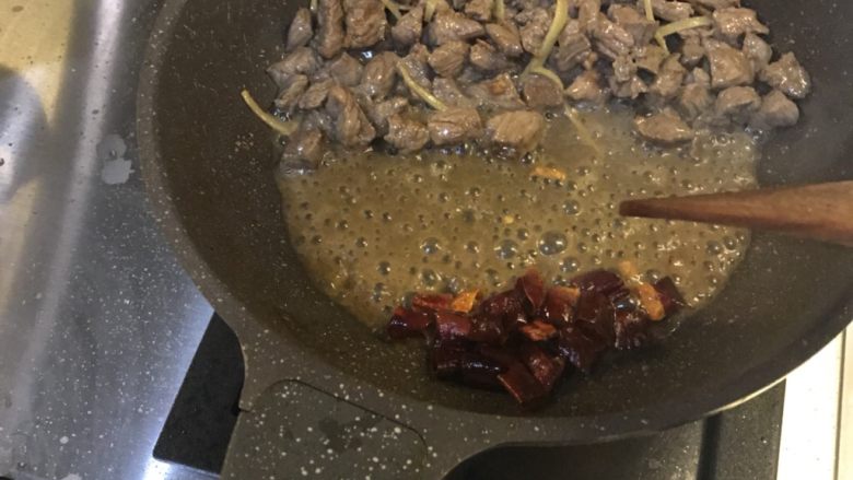 小炒牛肉,牛肉变色后，放到一盘，把干辣椒放入，小火翻炒干辣椒