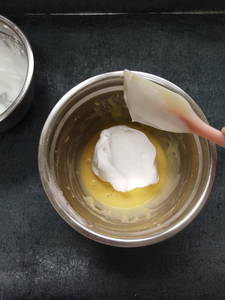 雪芳纸杯蛋糕,在蛋黄糊中加入三分之一蛋白翻拌均匀