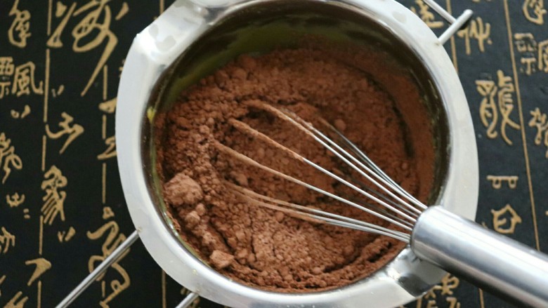 法式巧克力慕斯球,将黑巧克力趁热放入，搅拌至溶化后加入可可粉，拌匀