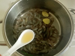 小白虾拌韭菜,小虾冷水下锅，放入二片姜片和一勺料酒。