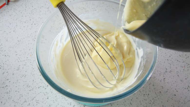 爆浆海盐奶盖蛋糕,将锅中的卡仕达酱加入芝士酱中，用手动打蛋器搅拌均匀，放凉将海盐奶盖酱装入裱花袋中备用。