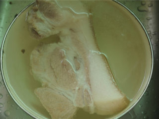 酱烧回锅肉,将浮沫撇去，看到猪肉完全变色后，将其捞出，用凉水紧一下