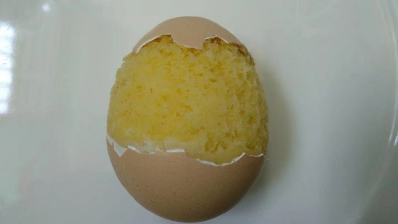 萌萌小鸡蛋糕,取出放凉，如有溢出的整理一下。鸡蛋中间敲碎把壳随意拨开，剥成喜欢的样子。