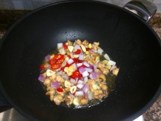 小煎鸡,放入大蒜、生姜、洋葱、泡椒翻炒出香味。