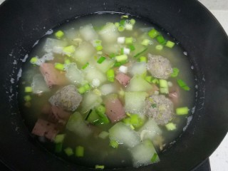 冬瓜🐷肝丸子虾米汤。,倒入蒜苗，根据个人口味加入适量盐，搅拌均匀，关火。