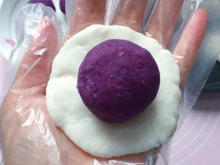 紫薯糯米饼,取一份糯米皮用手掌心按扁，放上一个紫薯泥