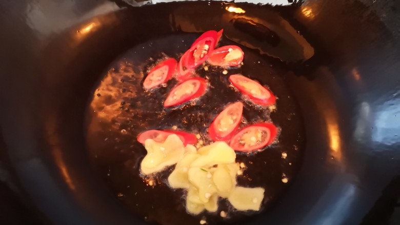 竹笋炒腊肉,油锅烧热放入红椒和姜片爆香