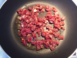 红椒炒牛肉粒,加入腌制好的牛肉粒。