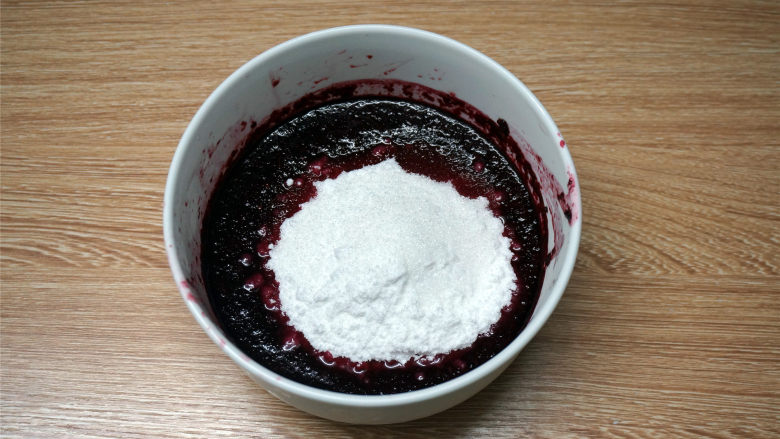 熊本熊桑葚慕斯,将40克细砂糖加入到桑葚果泥中，拌至糖完全融合，放入一旁备用。
