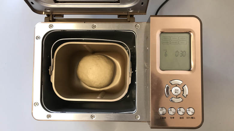 牛奶胚芽面包卷,将面团收圆后，放入面包机内，设置发酵30分钟