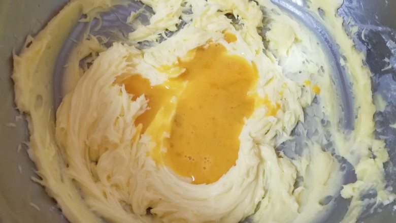 双色曲奇饼干,分两次加入全蛋液，第一次加入以后打发至蛋液和黄油完全融合，才能再次加入。