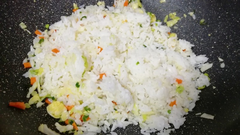 泡菜红油炒饭,下入米饭翻炒均匀。