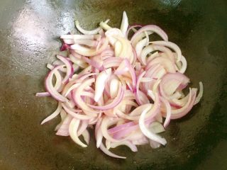 洋葱炒肉丝,锅中底油放入洋葱丝翻炒均匀。