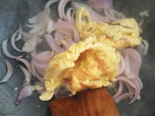 洋葱炒鸡蛋,洋葱变色变软后加入鸡蛋。