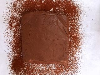 超好吃的生巧克力,把定型的巧克力脱模倒扣在油纸上，撕下保鲜膜