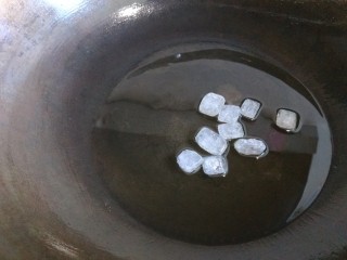 秘制红烧排骨,另起锅倒入适量油，放9块冰糖熬制。