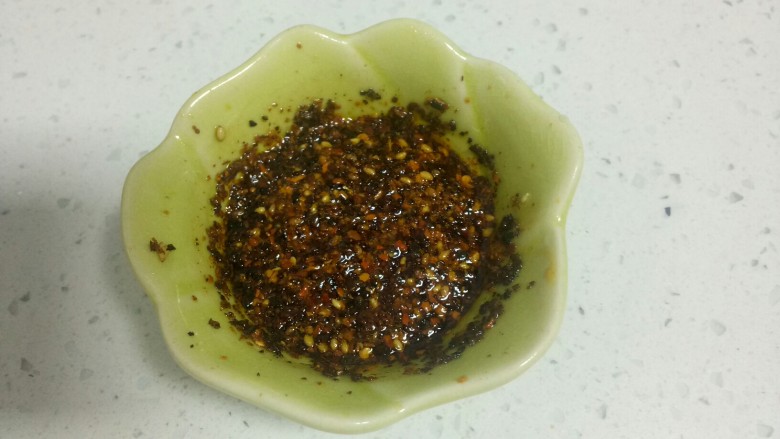 不用洗面的黑米凉皮,小碗中放入适量椒盐、辣椒面、芝麻，把油烧热倒入碗里，搅拌均匀。