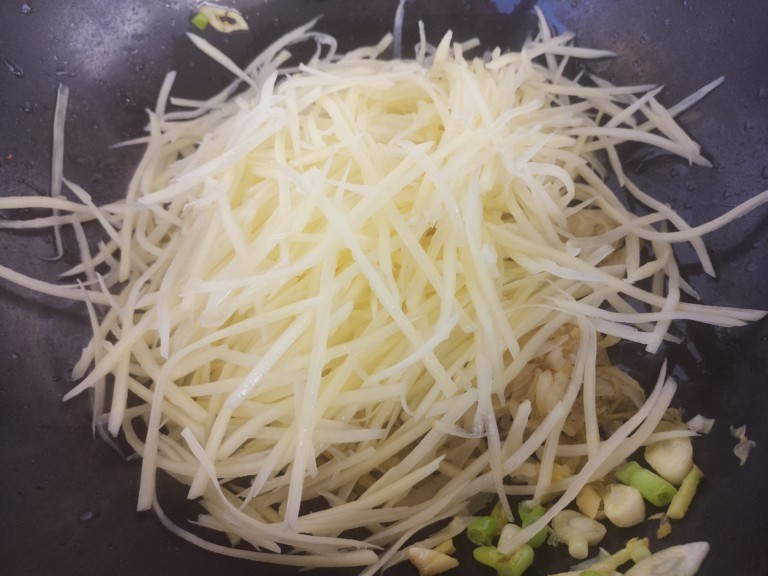 家常酸菜炒土豆丝,再放入土豆丝。