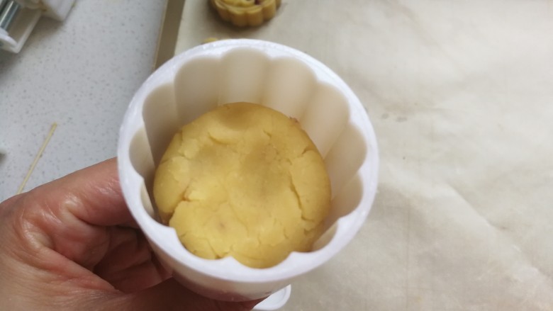 清凉甜点~蔓越莓绿豆糕,然后把月饼模具提前刷上一层融化的黄油或植物油，再取一份豆沙团放入模具中用手稍微压一下。