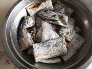 家常焖带鱼,带鱼清洗干净，去掉内脏，剪去鱼鳍，切段倒入料酒拌匀，腌制30分钟，目的是去腥，

