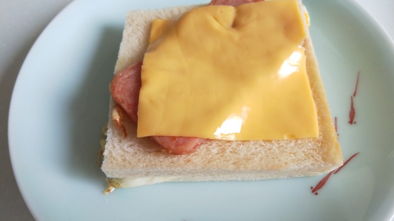自制午餐肉三明治,上面在放一片芝士片。