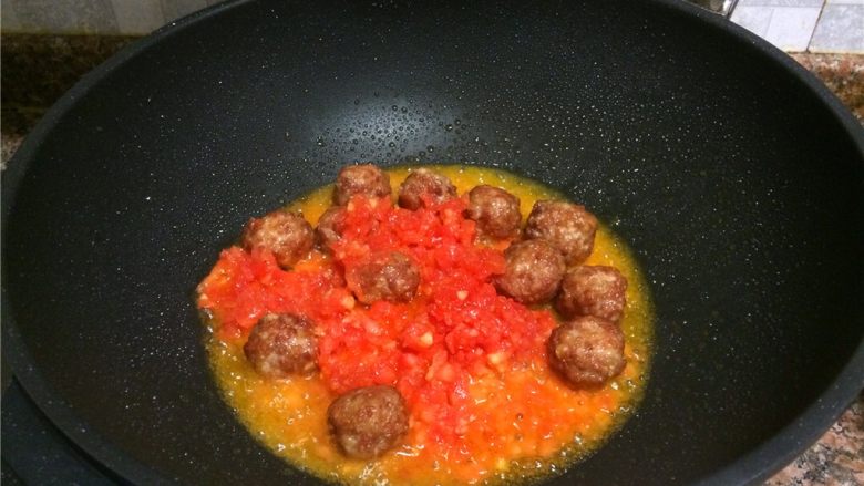 茄汁酸甜丸子,放入番茄碎翻炒均匀，将番茄中的水份煮干。