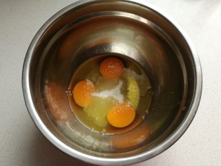 香橙海绵纸杯蛋糕,鸡蛋打入无水无油的干净盆中，分两次加入白糖进行打发。