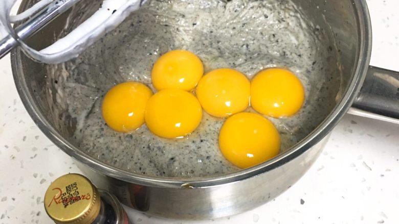 芝麻核桃蛋糕,加入蛋黄和<a style='color:red;display:inline-block;' href='/shicai/ 780'>香草精</a>，这次的鸡蛋有一个是双黄鸡蛋。先用打蛋器后用刮刀翻拌。