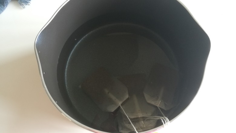 港式奶茶,把<a style='color:red;display:inline-block;' href='/shicai/ 156925'>水</a>倒入奶锅中，茶包放入奶锅中，我用的立顿的，如果家里有红茶，两勺也可以，煮完过滤就好