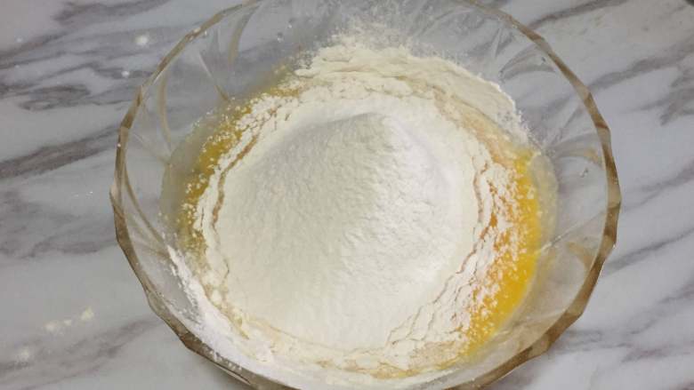 仿真栗子蛋糕,然后，我们先把面粉和泡打粉混合后再过筛到蛋液中。