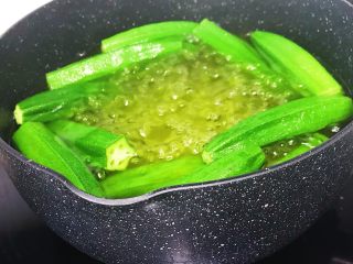 快手小食：凉拌秋葵,锅里烧水放入适量食盐和色拉油 水沸后放入秋葵焯熟捞出沥干