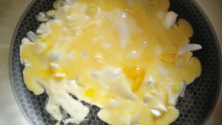 西兰花蛋炒饭,倒入打散的鸡蛋炒碎。