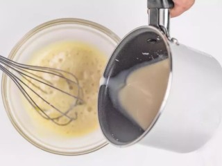 珍珠奶茶慕斯,将温度降至60°左右红茶奶液缓慢倒入蛋黄液中，不停搅拌。