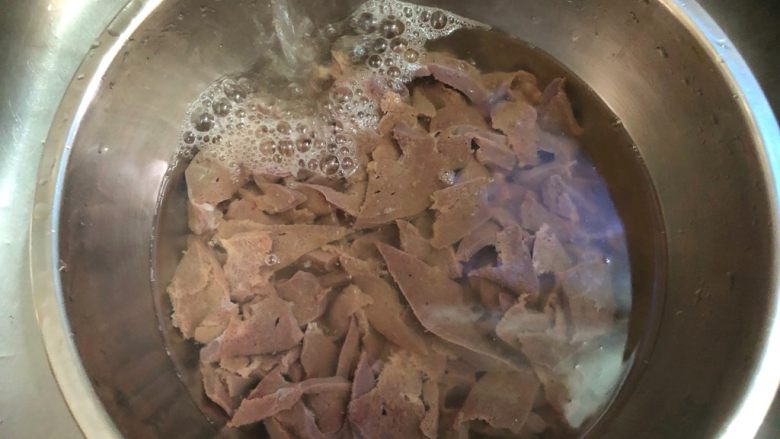 蒜苗炒猪肝,把猪肝放入大碗里，用自来水一直冲洗，冲到水清为止